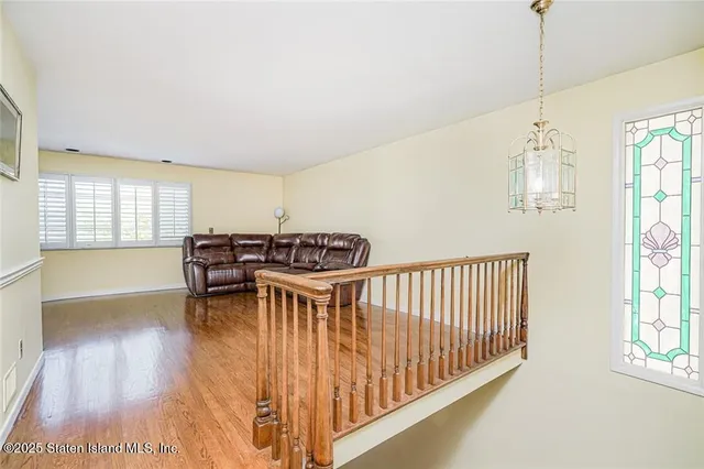a view of a room with furniture and wooden floor
