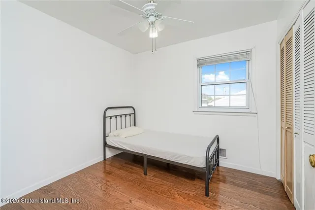 a view of a livingroom with wooden floor and a window