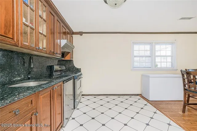 a kitchen with granite countertop white cabinets and white appliances