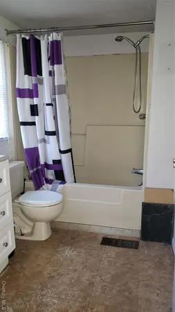 a bathroom with a toilet and a bathtub