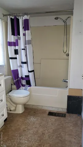 a bathroom with a toilet and a bathtub