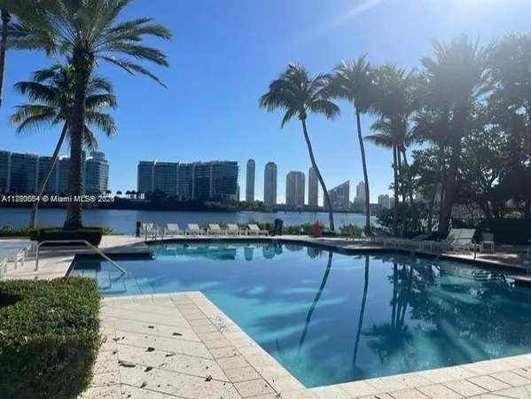 a view of a swimming pool with a table and chairs