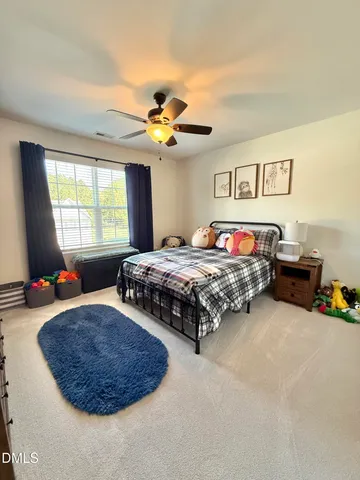 a living room with furniture a flat screen tv and a window