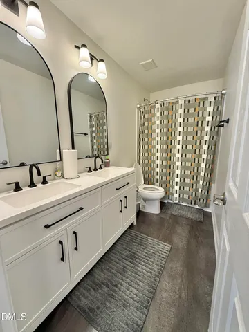 a living room with furniture and a ceiling fan