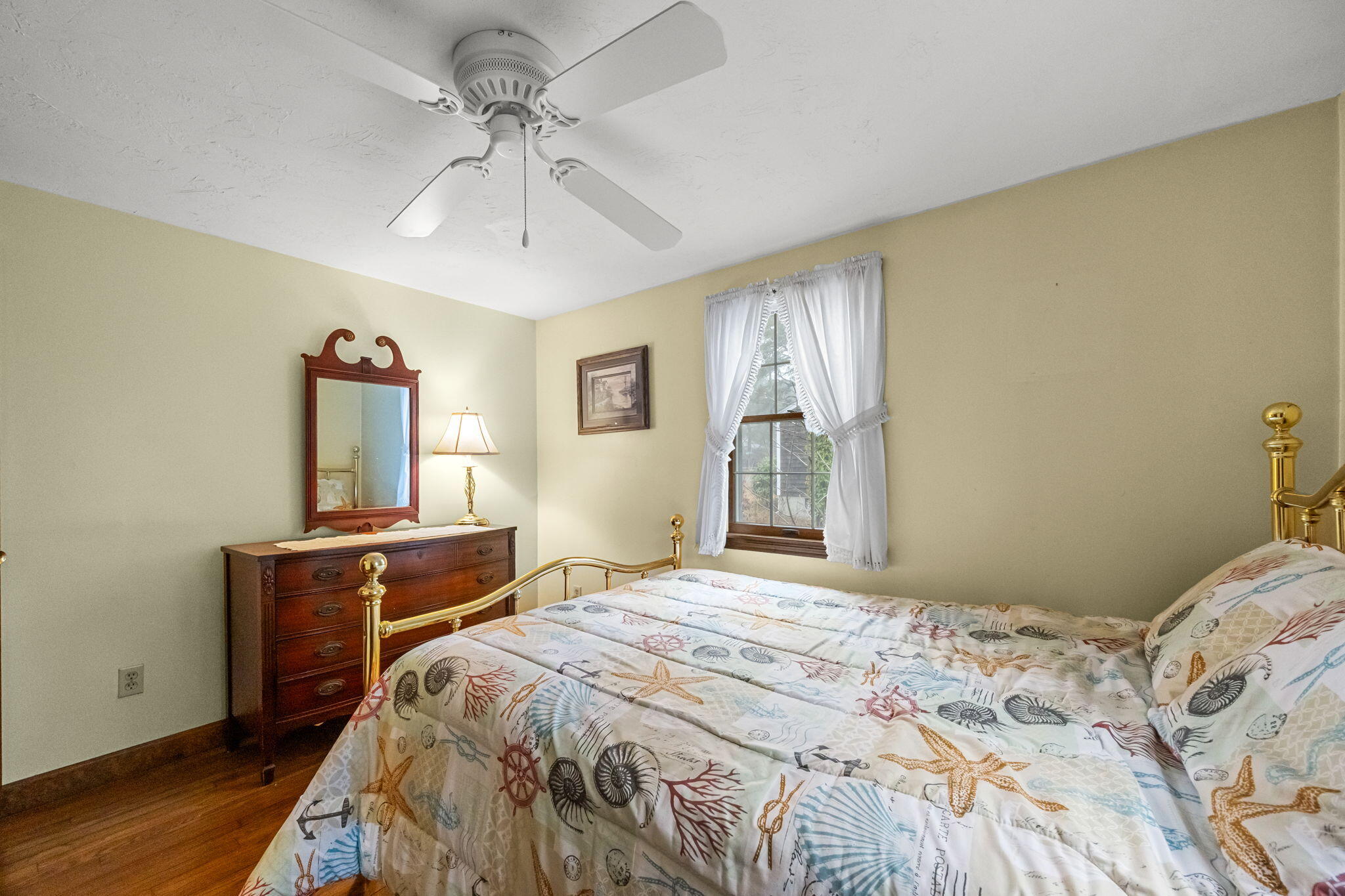 21 Princes Street Harwich, MA 02645 - Photo 22 of 30 a bedroom with a bed and a chandelier