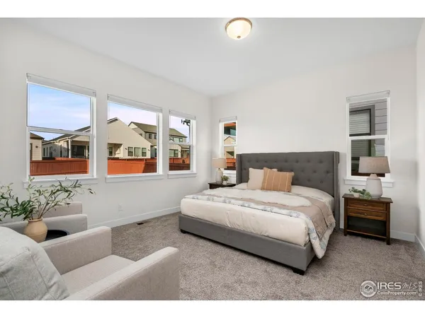 a dining room with furniture wooden floor a rug a potted plant and a chandelier