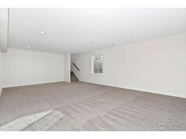a view of an empty room with a kitchen