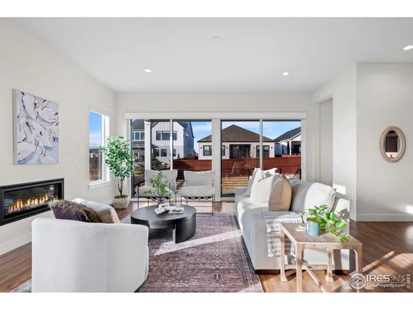 a living room with furniture and kitchen view