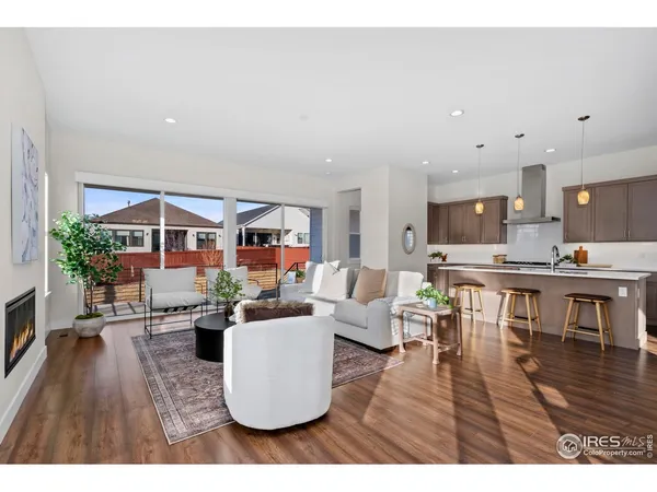 a living room with furniture potted plant and a table