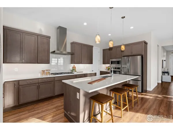 a living room with lots of furniture and kitchen view