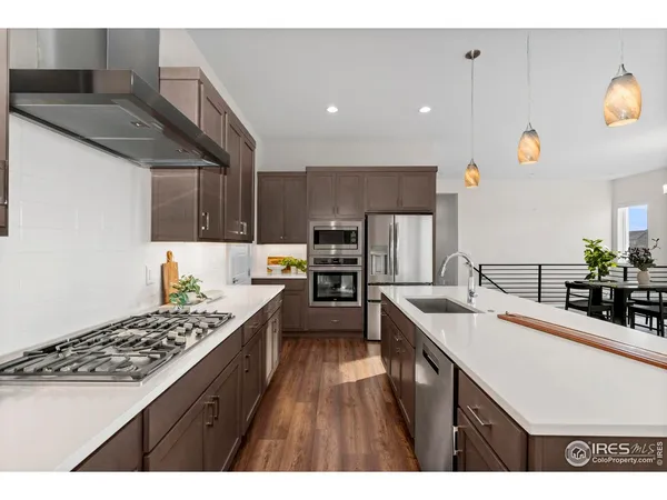 a kitchen with stainless steel appliances kitchen island granite countertop a sink and a stove