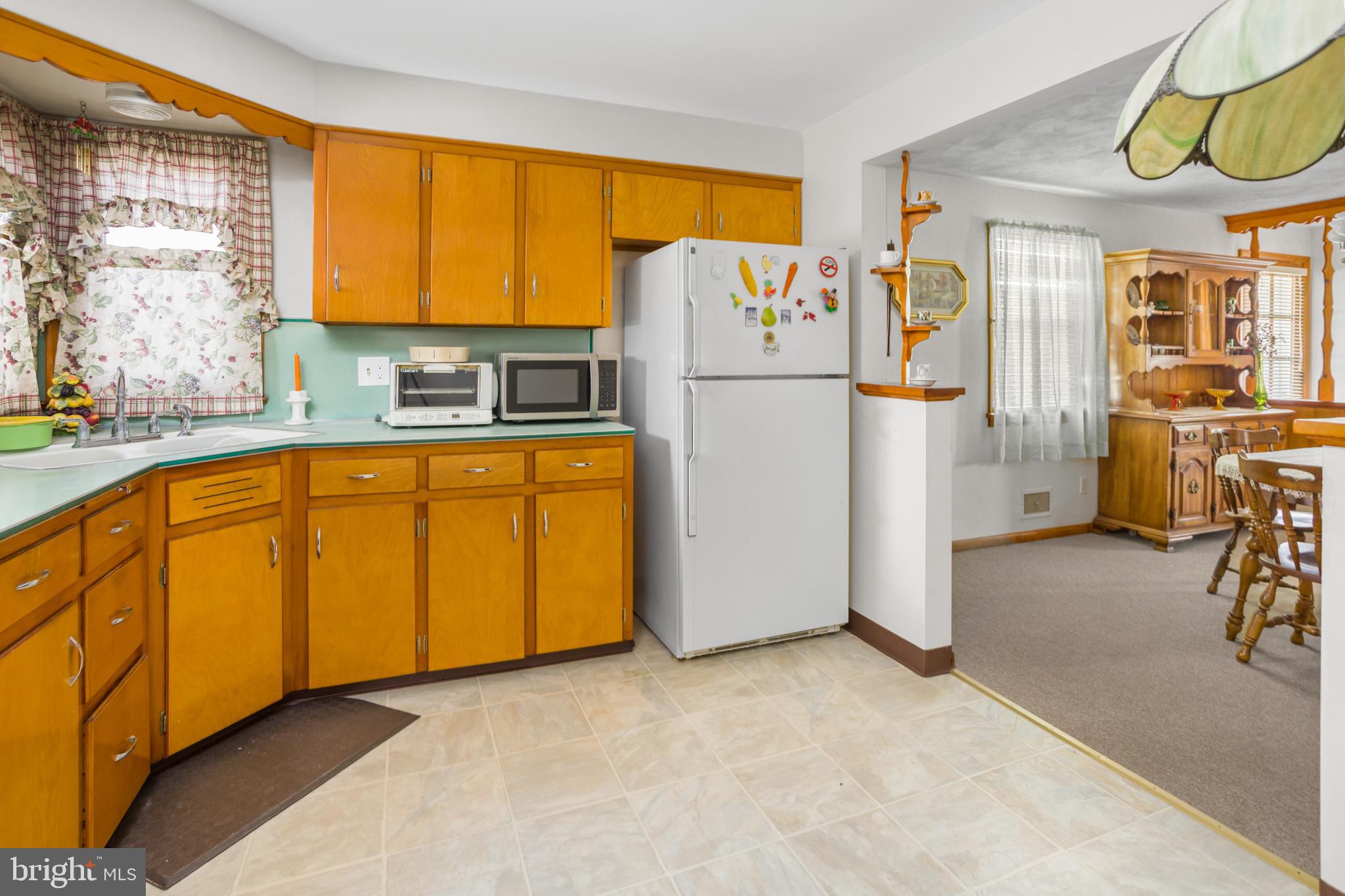32 Hartman Drive Hamilton, NJ 08690 - Photo 11 of 23 a view of a kitchen with fridge and workspace