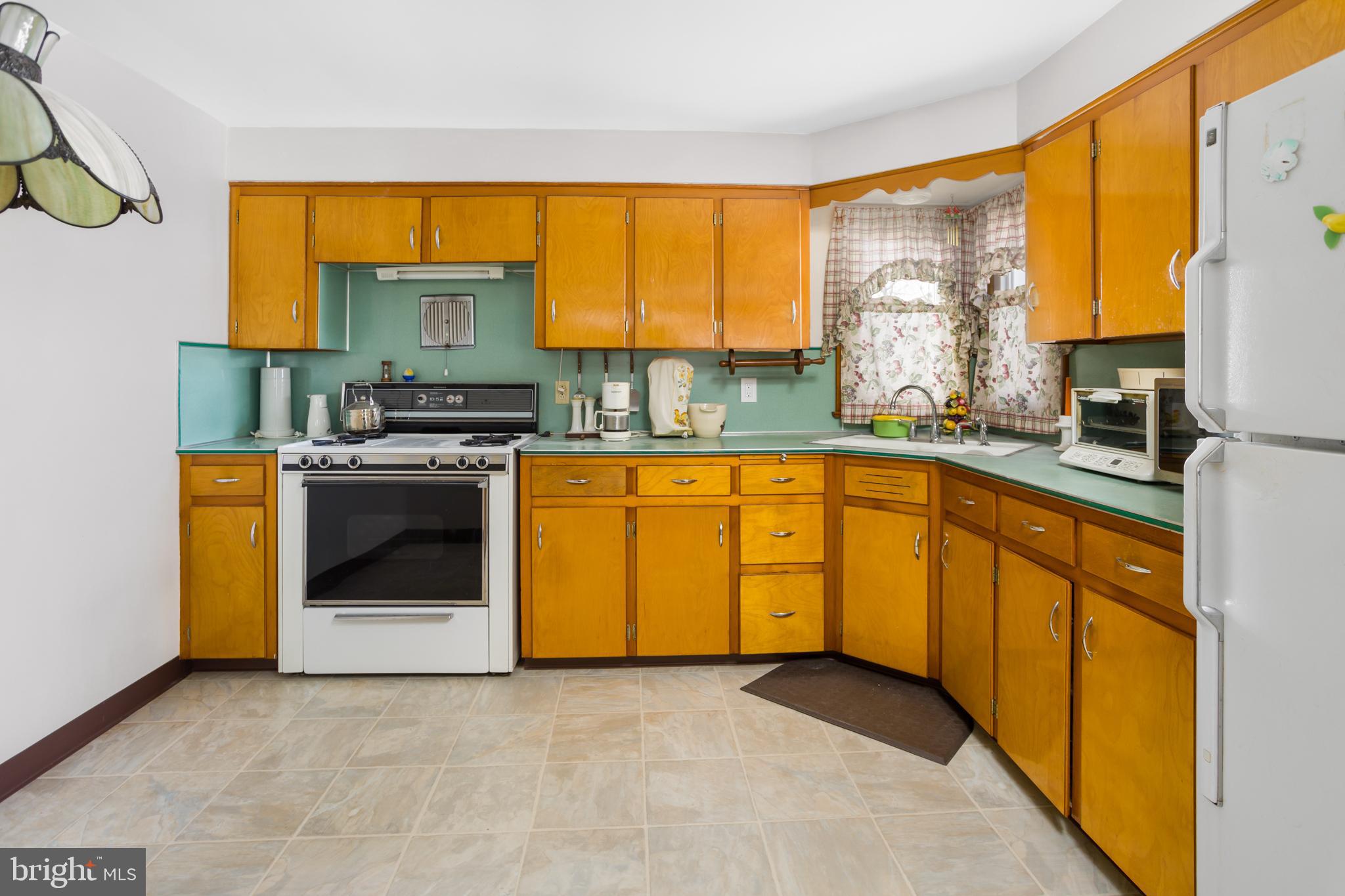 32 Hartman Drive Hamilton, NJ 08690 - Photo 10 of 23 a view of a kitchen with a sink and a stove top oven