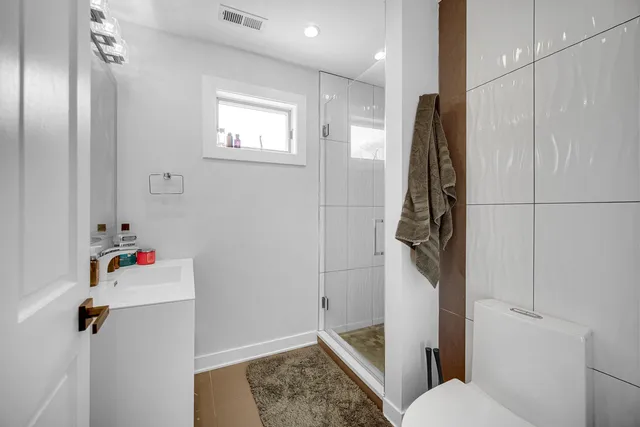 a bathroom with a shower and toilet