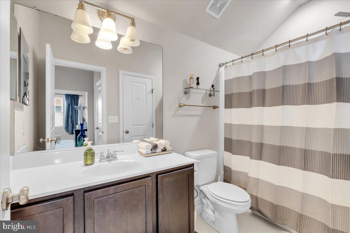 49 Steeplechase Drive La Plata, MD 20646 - Photo 26 of 27 a bathroom with a sink a toilet a mirror a lamp and shower