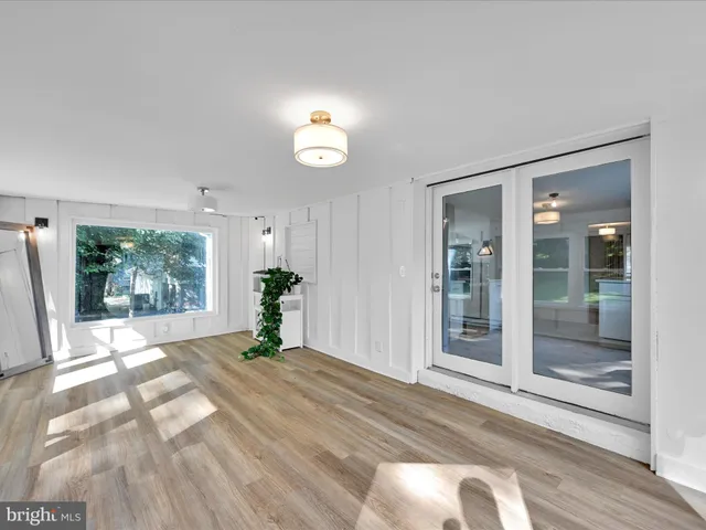 a view of a room with wooden floor and a large window