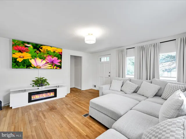 a bedroom with a bed a couch and painting on the wall