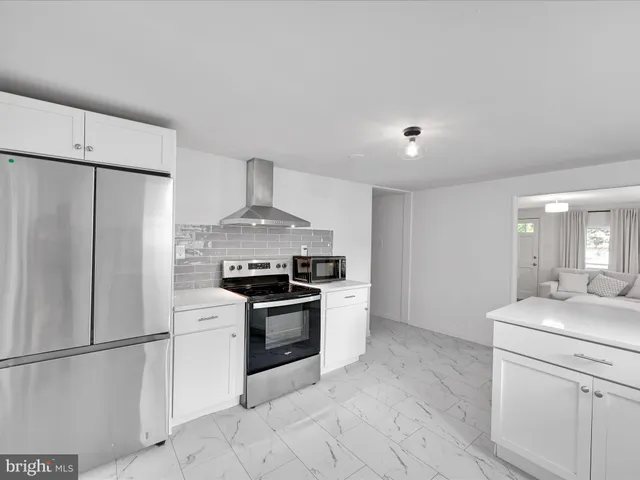 a kitchen with stainless steel appliances a refrigerator sink and stove