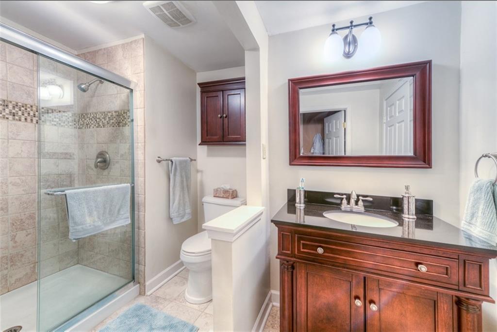 279 Shafer Road Coraopolis, PA 15108 - Photo 15 of 25 The master bath has been tastefully renovated with tile surround and dark wood accents. The adjoining walk-in closet makes preparing for your day a breeze.