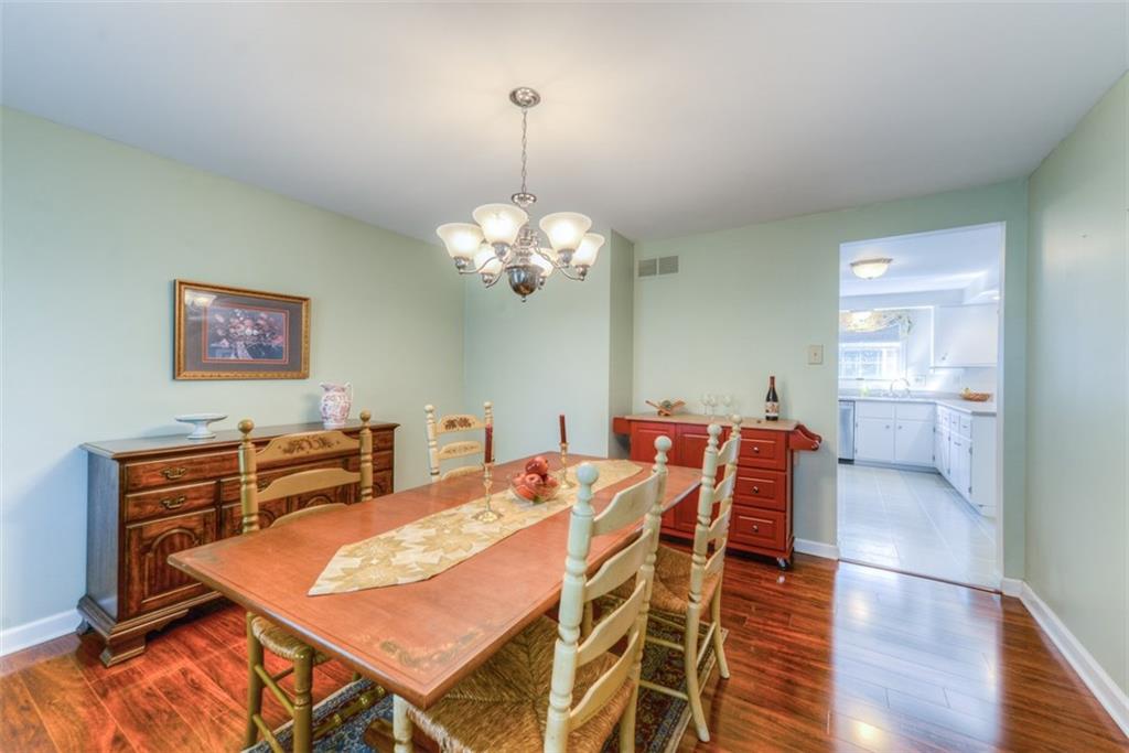 279 Shafer Road Coraopolis, PA 15108 - Photo 6 of 25 The dining room comfortably sits a full size table, credenza, and serving buffet. The beautiful wood laminate floors are durable and easy to clean.