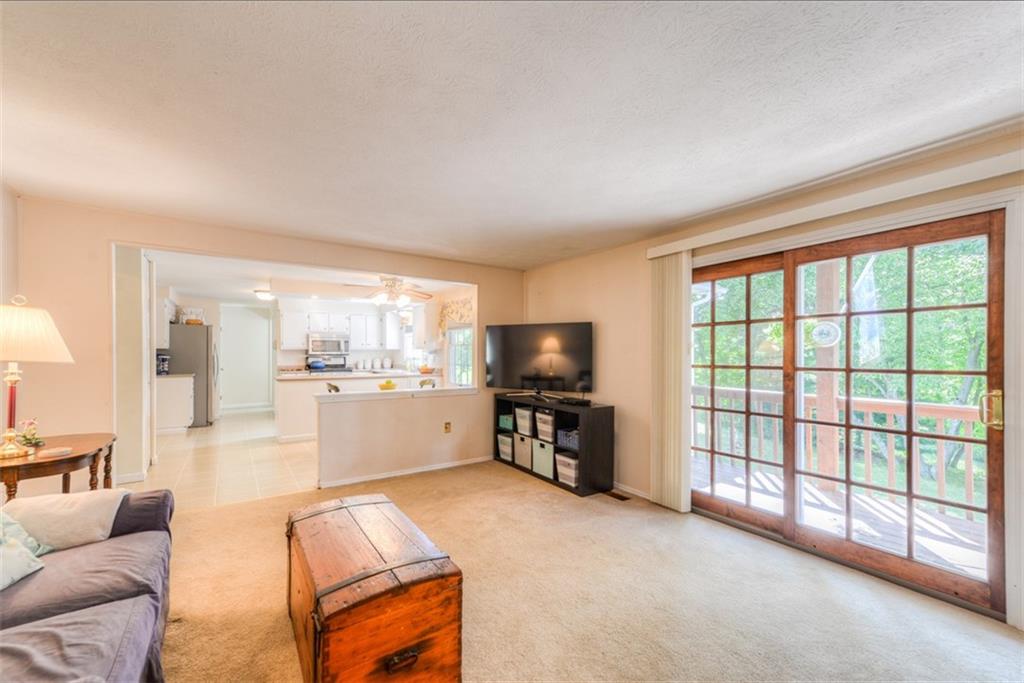 279 Shafer Road Coraopolis, PA 15108 - Photo 10 of 25 The family room is open to the breakfast nook and kitchen. Beautiful sliding glass doors provide access to the large deck. This home has fantastic flow for your family's daily lives and for entertaining.