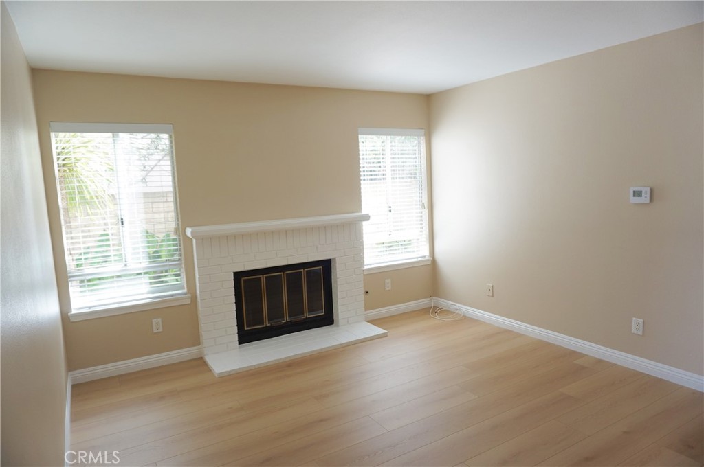 19584 Shadow Glen Circle Porter Ranch, CA 91326 - Photo 9 of 72 an empty room with windows and fireplace