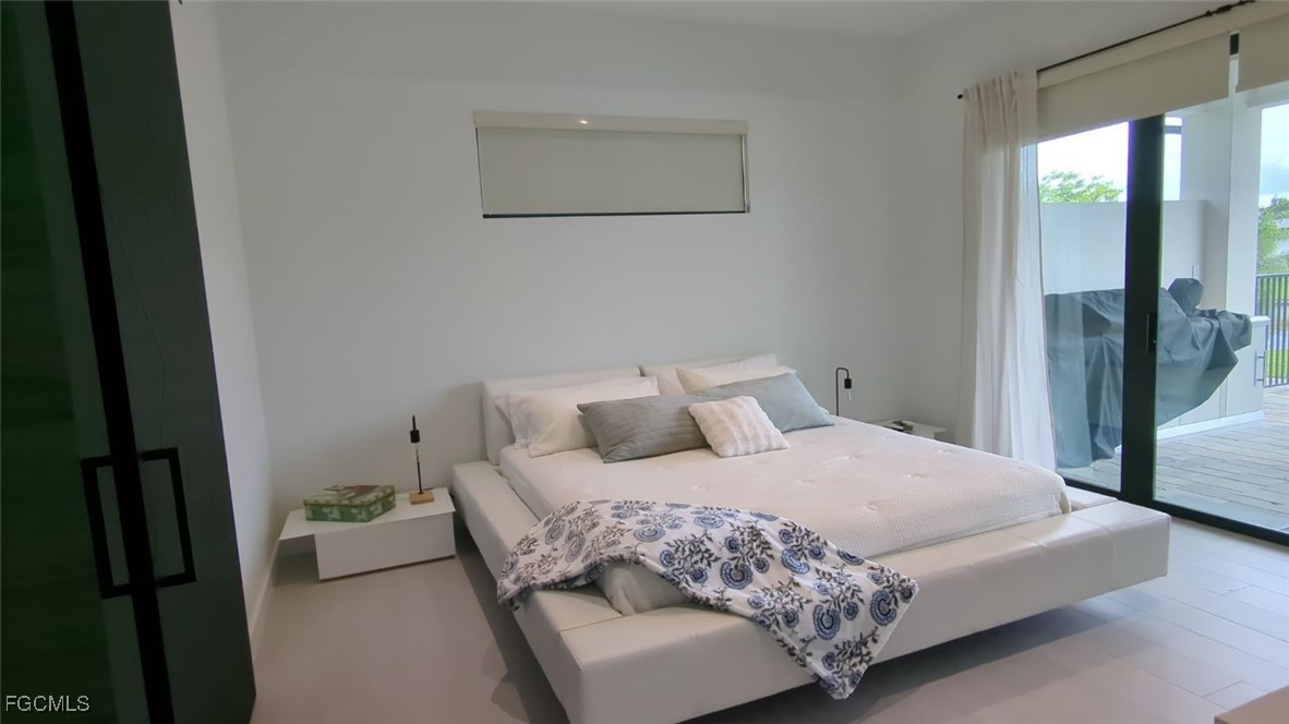 308 Southwest 13th Court Cape Coral, FL 33991 - Photo 11 of 15 a bedroom with a bed and a window