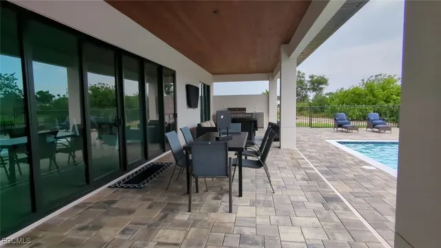 a view of a patio with a table chairs and backyard