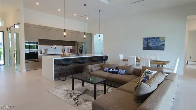 a living room with furniture and kitchen view