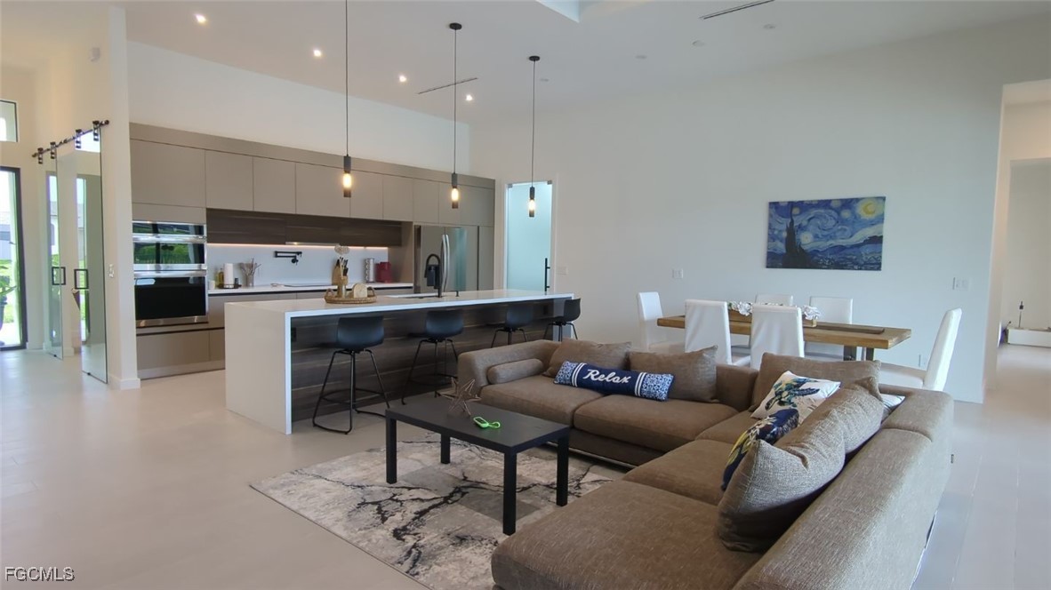 308 Southwest 13th Court Cape Coral, FL 33991 - Photo 3 of 15 a living room with furniture and kitchen view