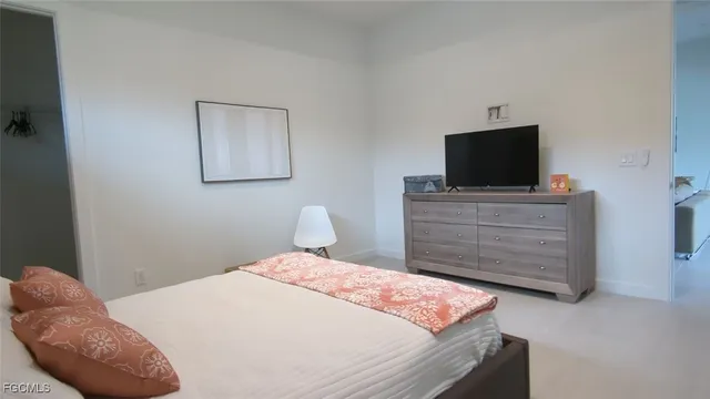 a bedroom with a bed and flat screen tv