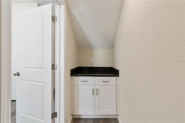 a bedroom with a bed furniture and painting on the wall