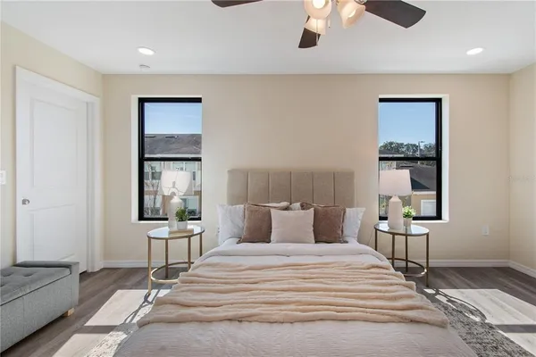 a bedroom with a bed and a chandelier