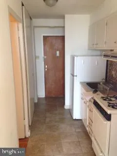 a kitchen with a stove and a refrigerator