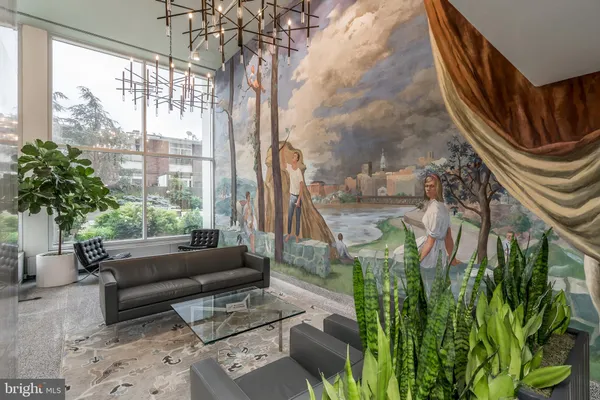 a living room filled with furniture and a chandelier