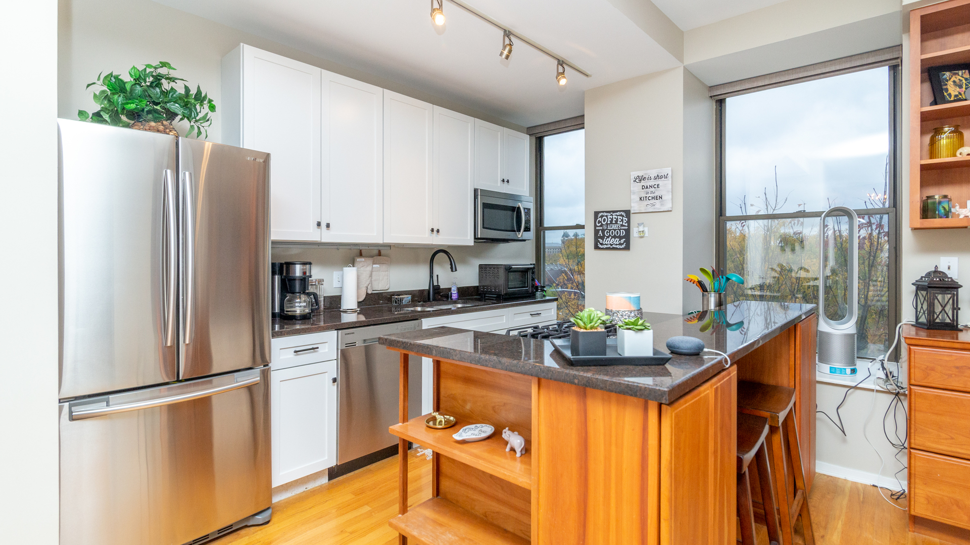 811 South Lytle Street, Unit 319 Chicago, IL 60607 - Photo 8 of 29 a kitchen with stainless steel appliances granite countertop a refrigerator a stove a sink dishwasher and white cabinets with wooden floor