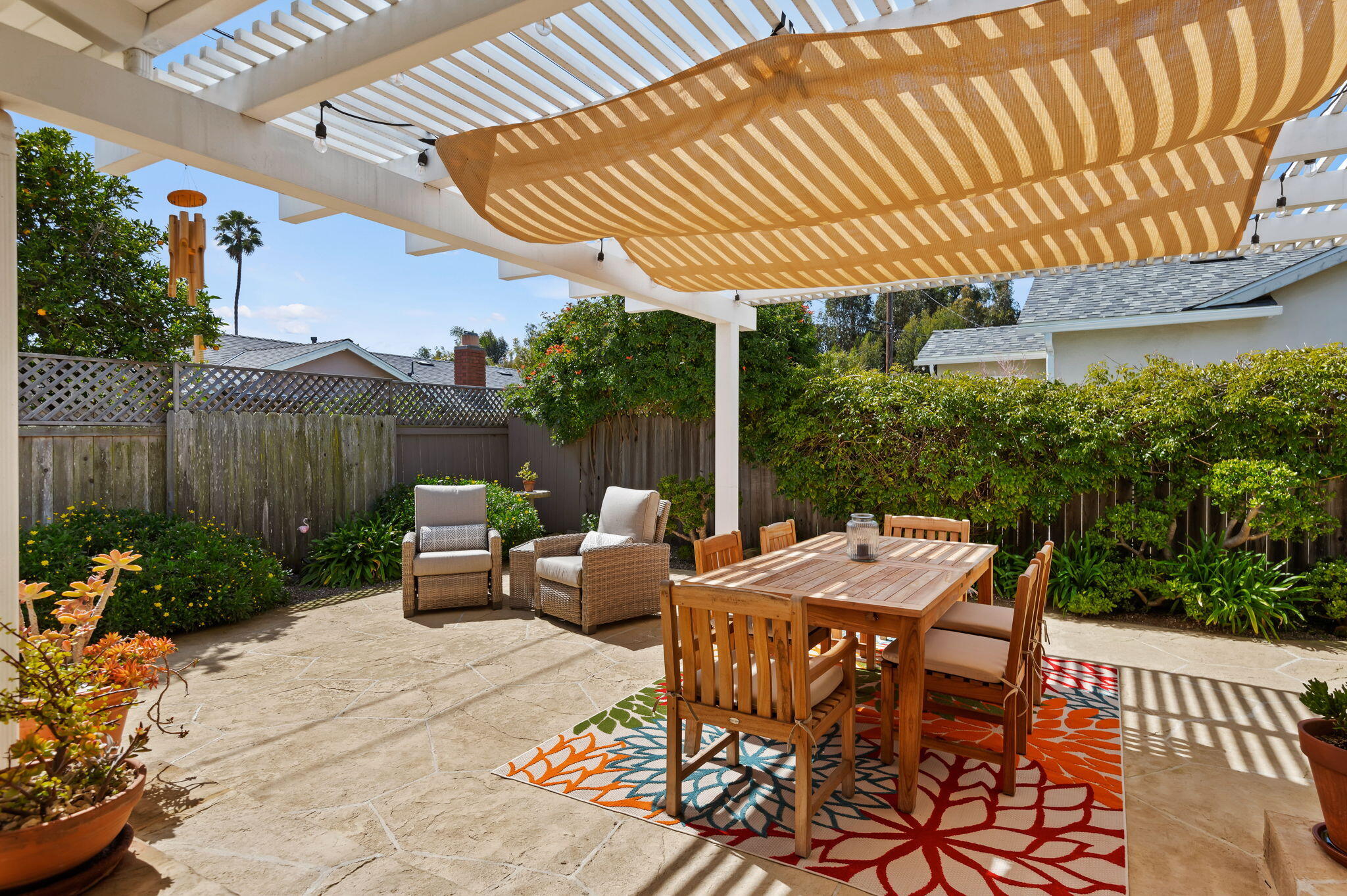 7635 Anchor Drive Goleta, CA 93117 - Photo 20 of 24 a patio with a table and chairs and potted plants