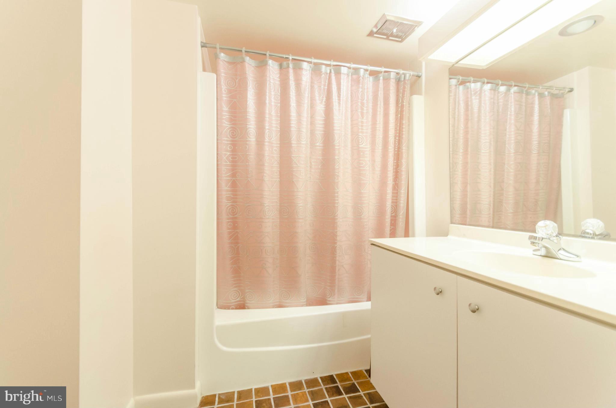 111 Hamlet Hill Road, Unit 606 Baltimore, MD 21210 - Photo 19 of 22 a bathroom with a granite countertop sink and a shower