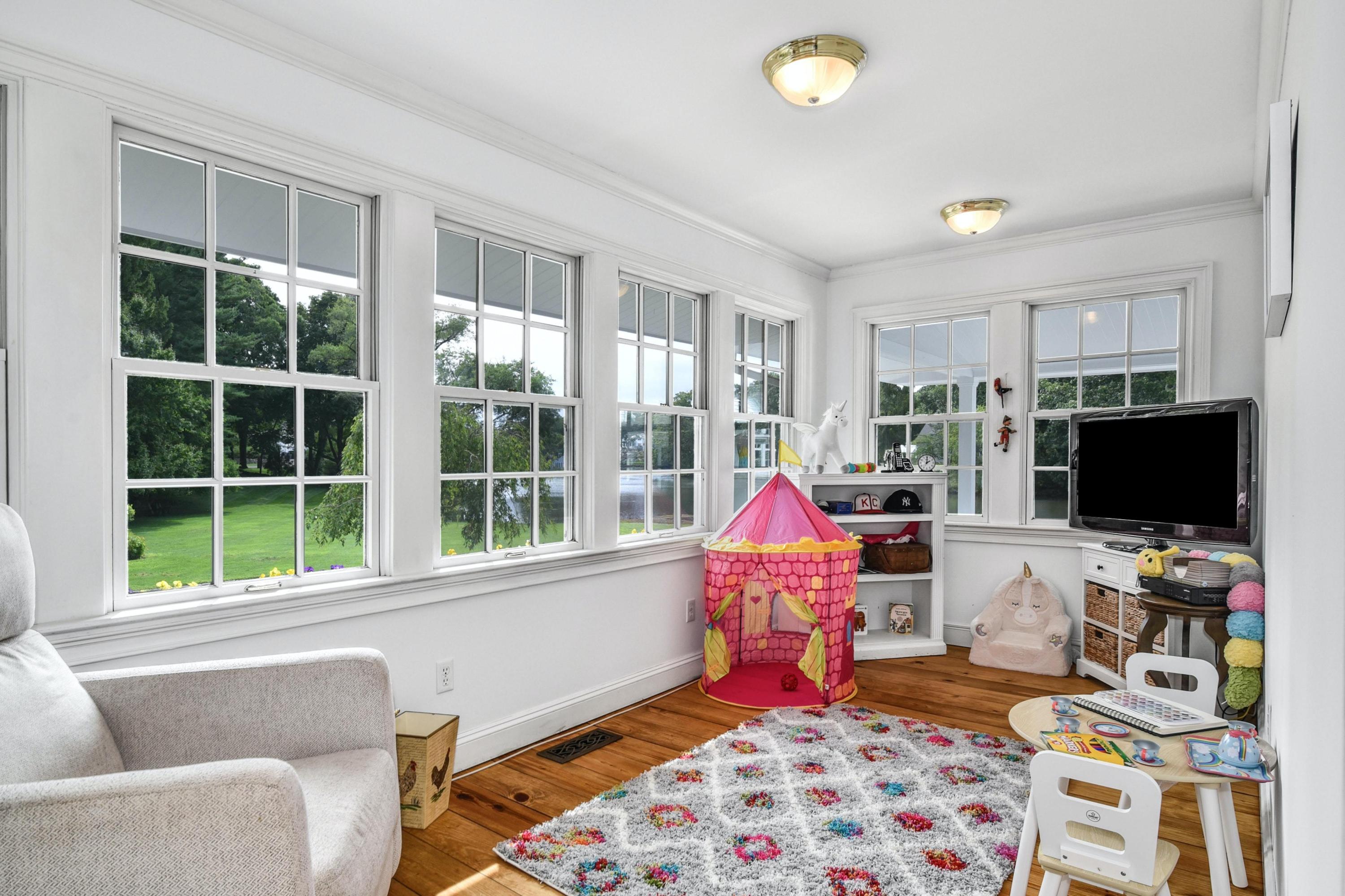 71 Goodwives River Road Darien, CT 06820 - Photo 21 of 39 a living room with furniture and a flat screen tv