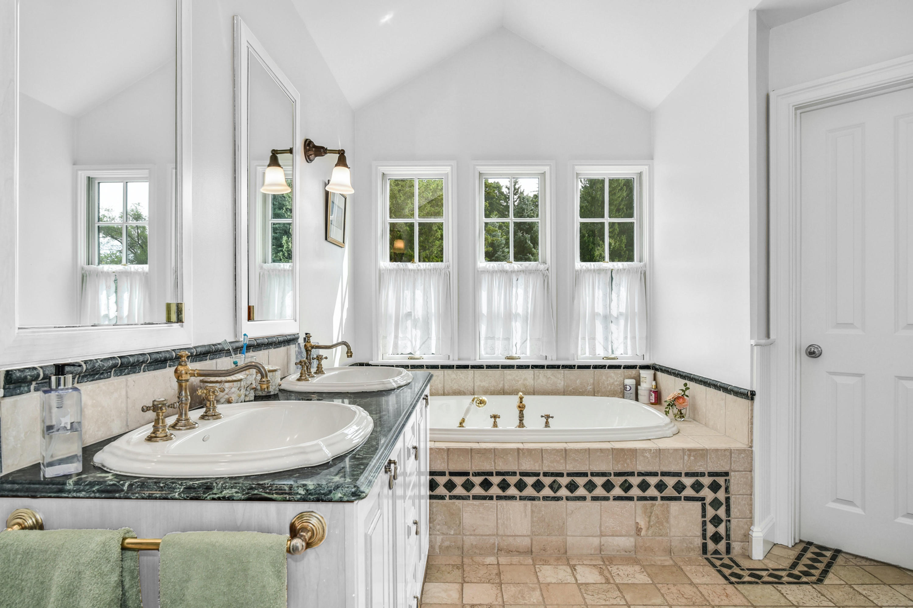 71 Goodwives River Road Darien, CT 06820 - Photo 29 of 39 a spacious bathroom with a granite countertop tub and a sink