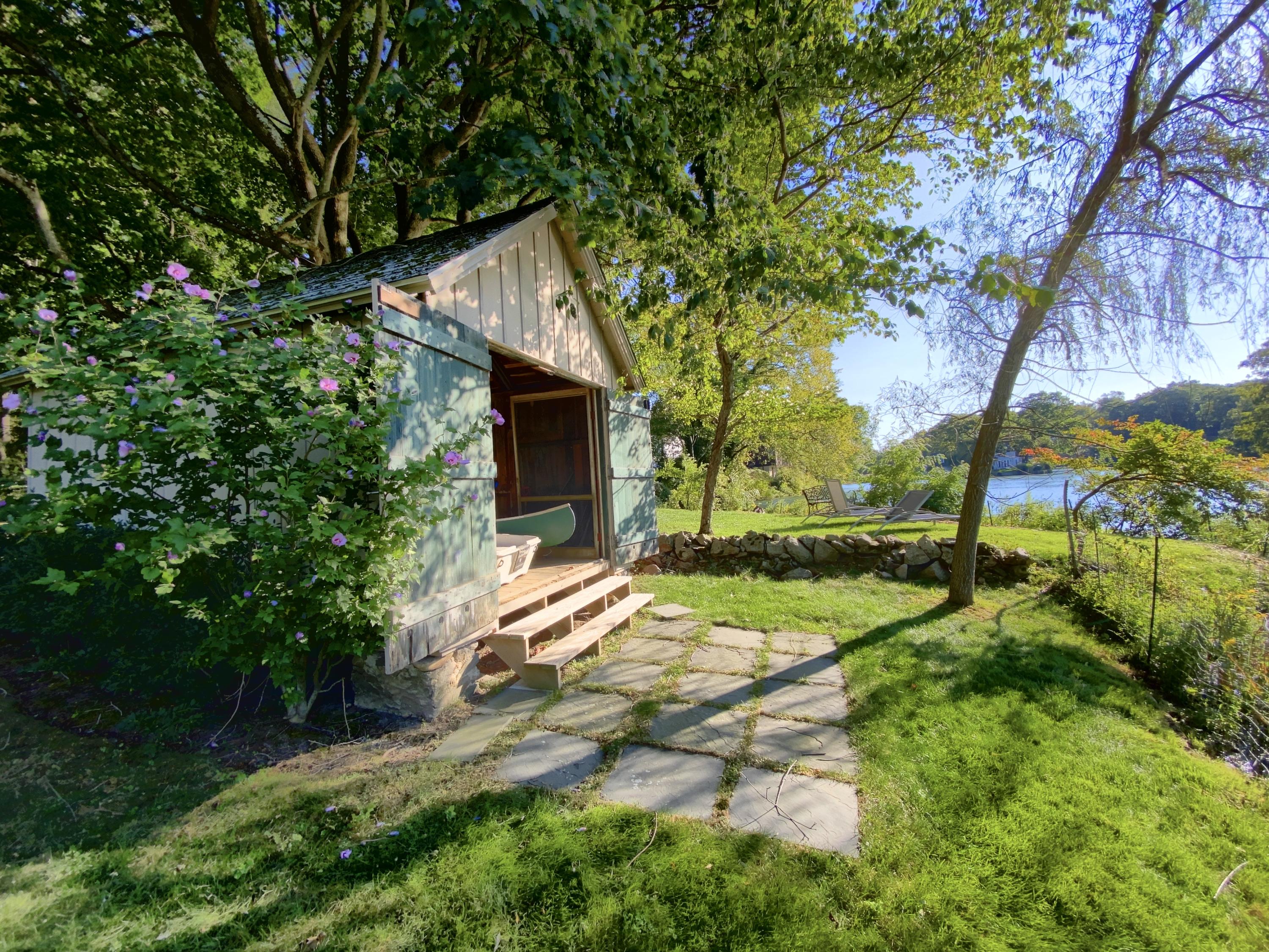 71 Goodwives River Road Darien, CT 06820 - Photo 35 of 39 a backyard of a house with plants and large trees