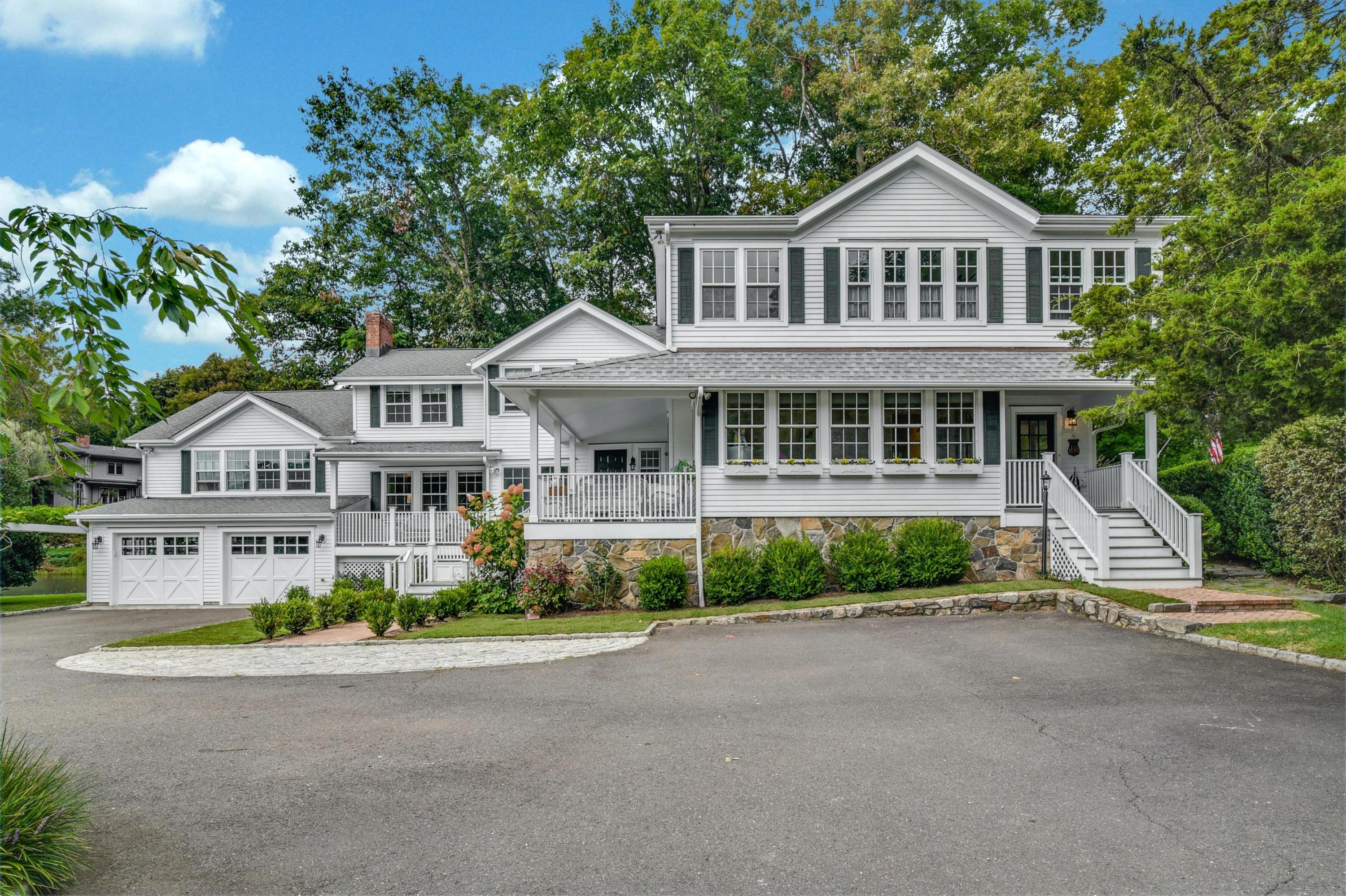71 Goodwives River Road Darien, CT 06820 - Photo 6 of 39 a front view of a house with a garden
