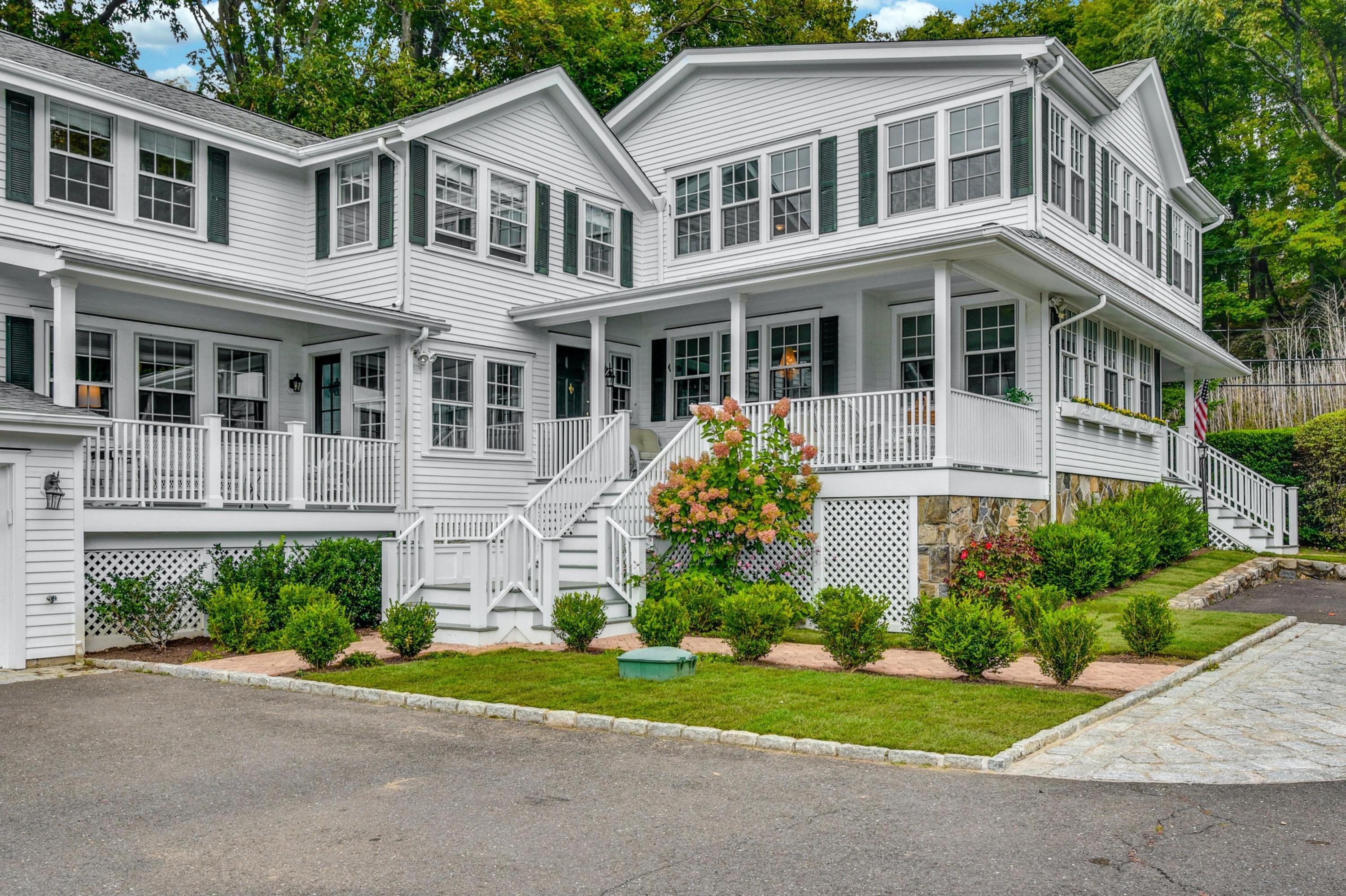 71 Goodwives River Road Darien, CT 06820 - Photo 7 of 39 a front view of a house with a yard and trees