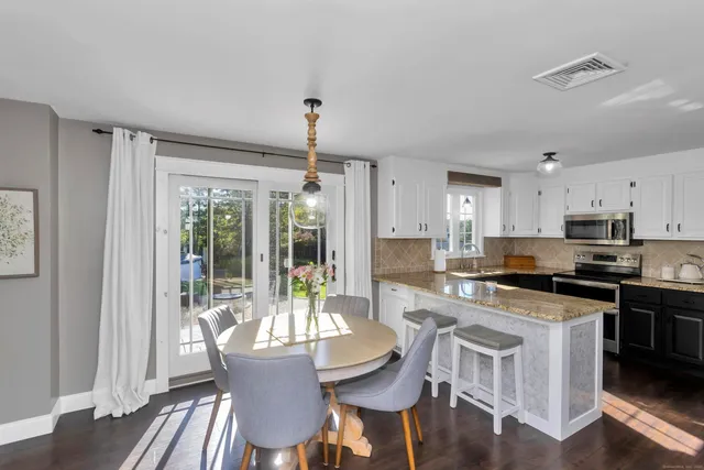 a view of a dining room with furniture window and wooden floor