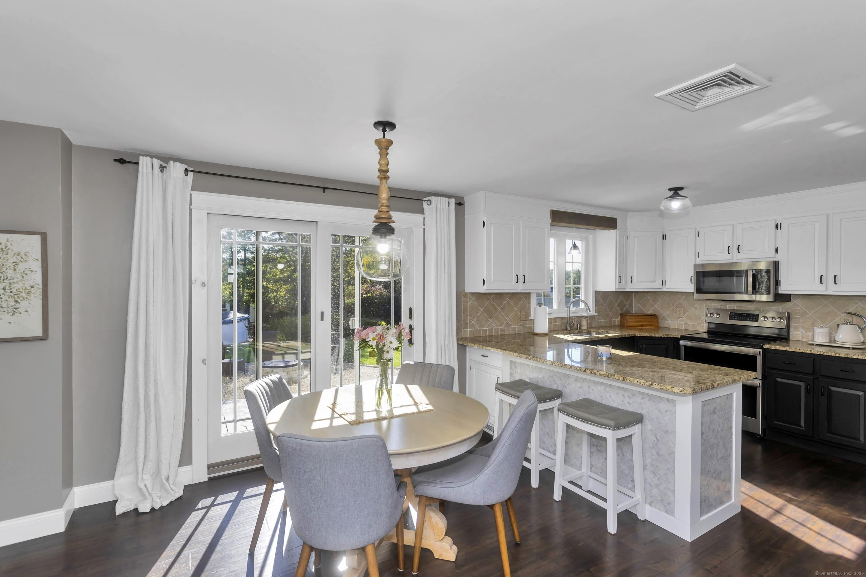 57 Kildeer Lane Suffield, CT 06078 - Photo 13 of 37 a view of a dining room with furniture window and wooden floor
