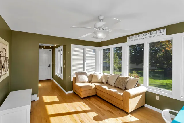 a living room with furniture and large windows