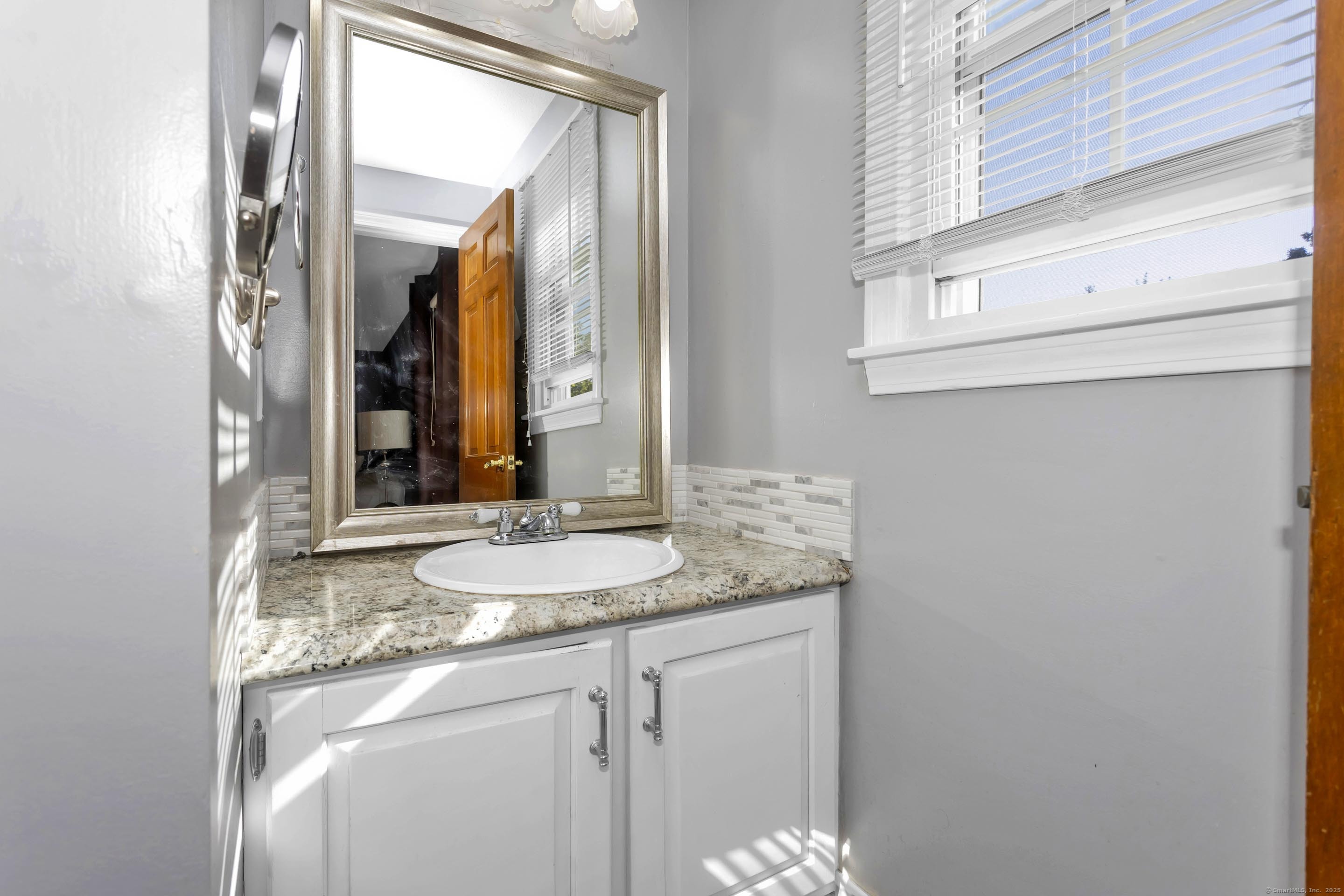 57 Kildeer Lane Suffield, CT 06078 - Photo 26 of 37 a bathroom with a granite countertop sink and a mirror