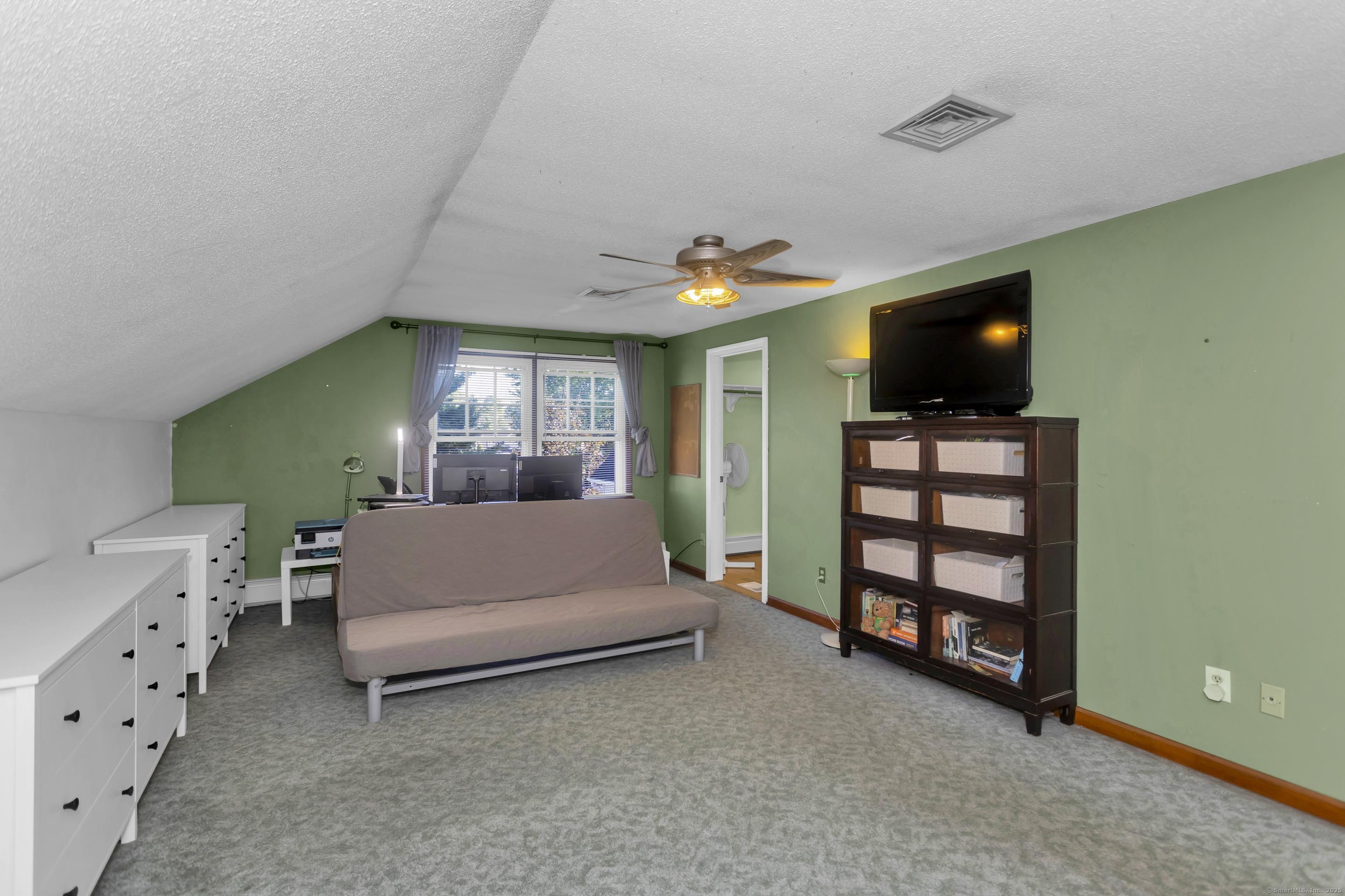 57 Kildeer Lane Suffield, CT 06078 - Photo 27 of 37 a living room with furniture and a flat screen tv