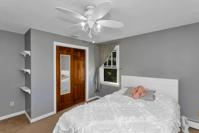 a bedroom with a large bed and a chandelier