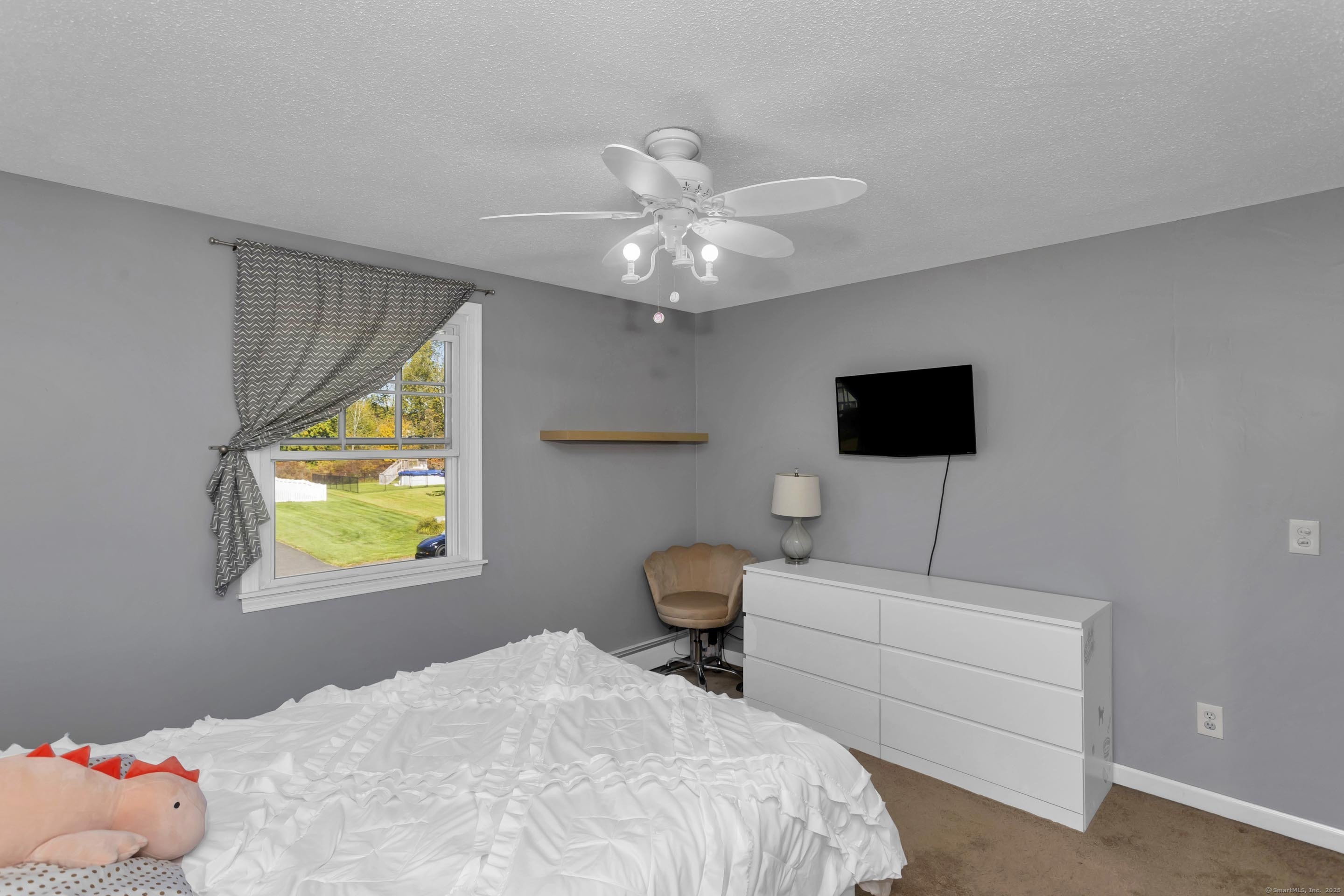 57 Kildeer Lane Suffield, CT 06078 - Photo 34 of 37 a bedroom with a bed and a chandelier